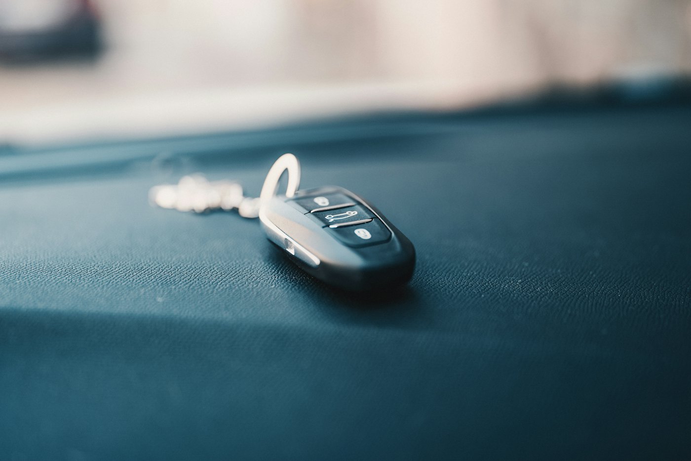 A black flip key on a car dashboard
